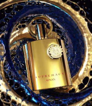 Afnan Supremacy Gold fragrance in a luxurious gold bottle with intricate design against a captivating backdrop.