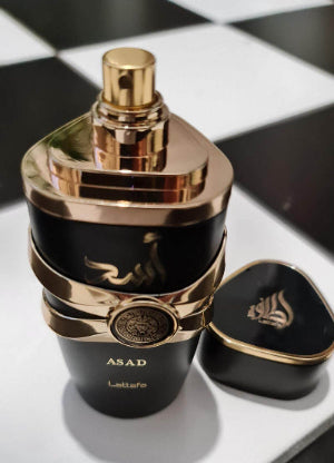 Lattafa Asad bold spicy vanilla men's fragrance bottle with elegant design and golden accents on a contrasting background.